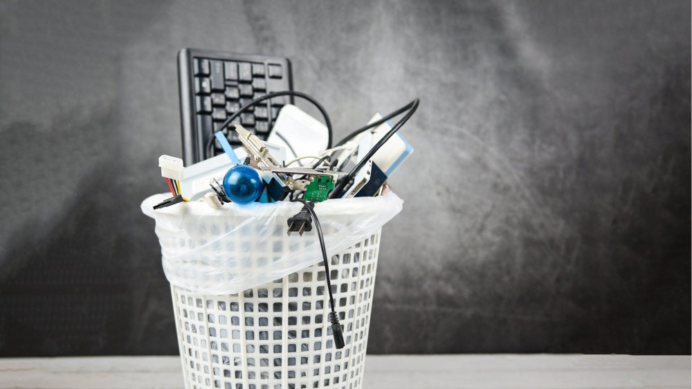 A waste basket filled with electronics