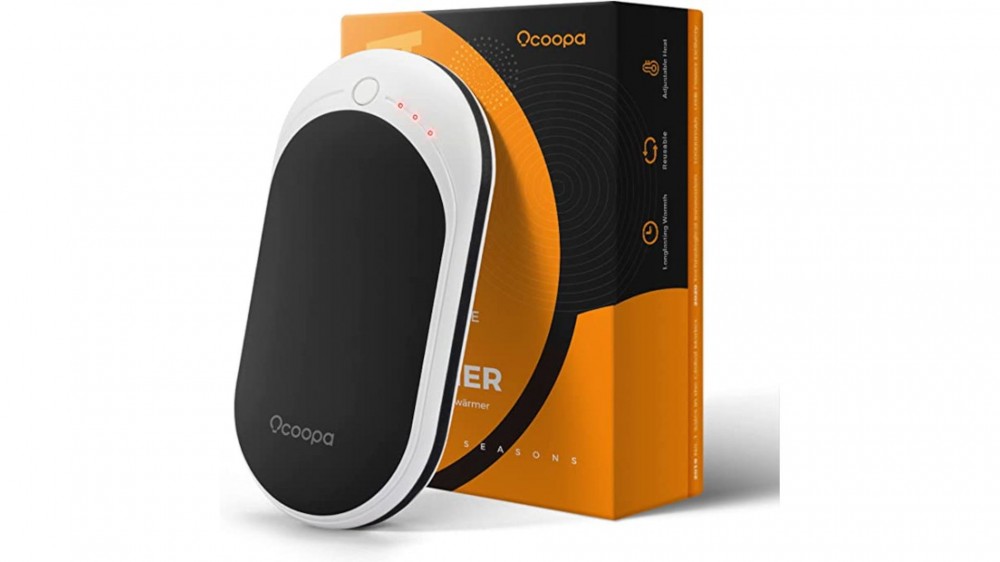 A rechargeable hand warmer is shown in front of a black and orange box.