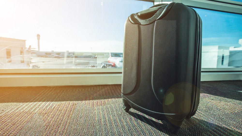 Suitcase sitting alone in an airport.