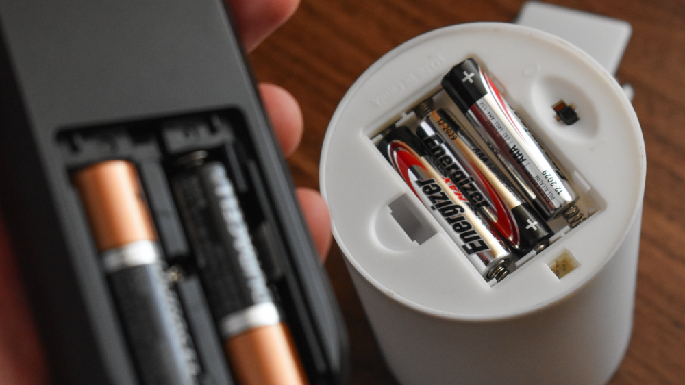 Disposable batteries in a TV remote and digital candle.