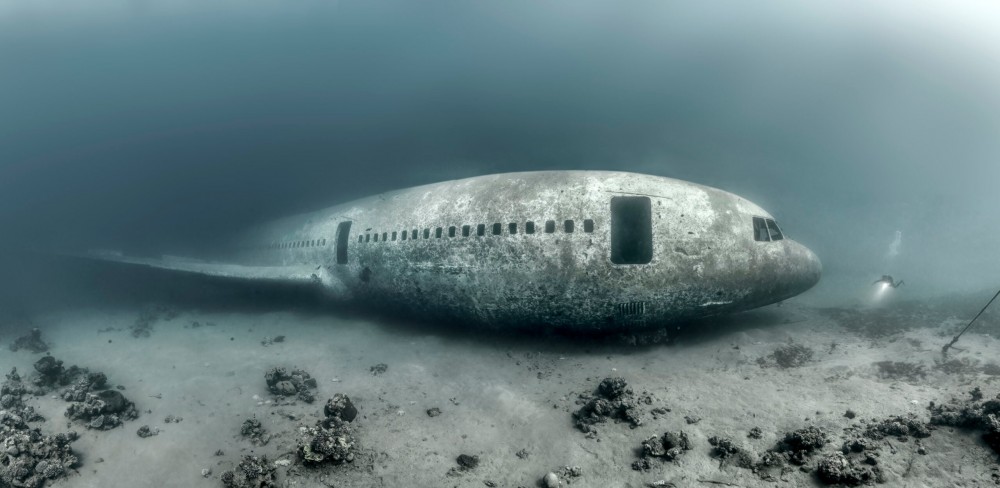 Scuba diver exploring sunken plane